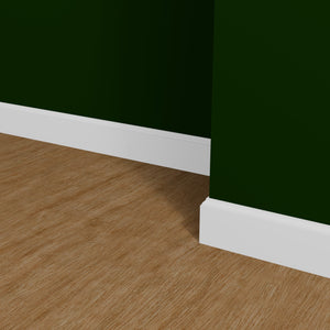 View of a room featuring the M618P Primed White Pine Wood Baseboard Moulding installed, measuring 9/16 in x 5-1/4 in x 16 ft, highlighting an elegant and clean finish, ideal for enhancing the aesthetics of any space.