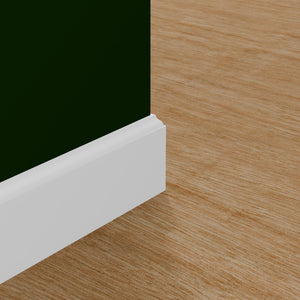 View of a room featuring the M618P Primed White Pine Wood Baseboard Moulding installed, measuring 9/16 in x 5-1/4 in x 16 ft, highlighting an elegant and clean finish, ideal for enhancing the aesthetics of any space.