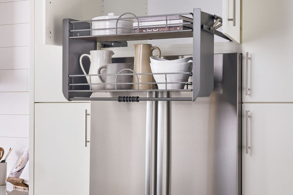 An innovative pull-out shelving system installed in a kitchen cabinet, demonstrating how it can optimize vertical space and facilitate access to items stored above.