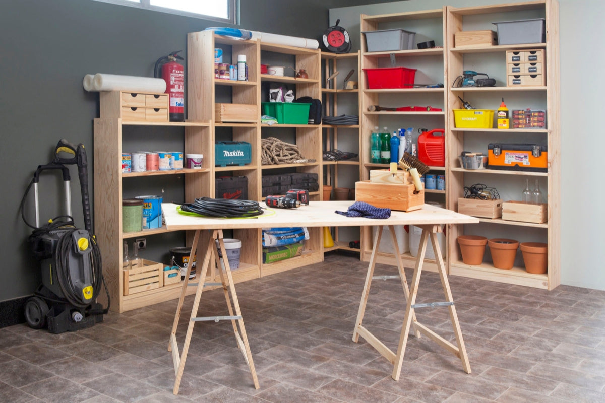 A well-organized woodworking workshop features wooden shelves filled with essential tools such as drills, saws, sanders, and measuring tools. A wooden workbench sits in the center, ready for woodworking projects.