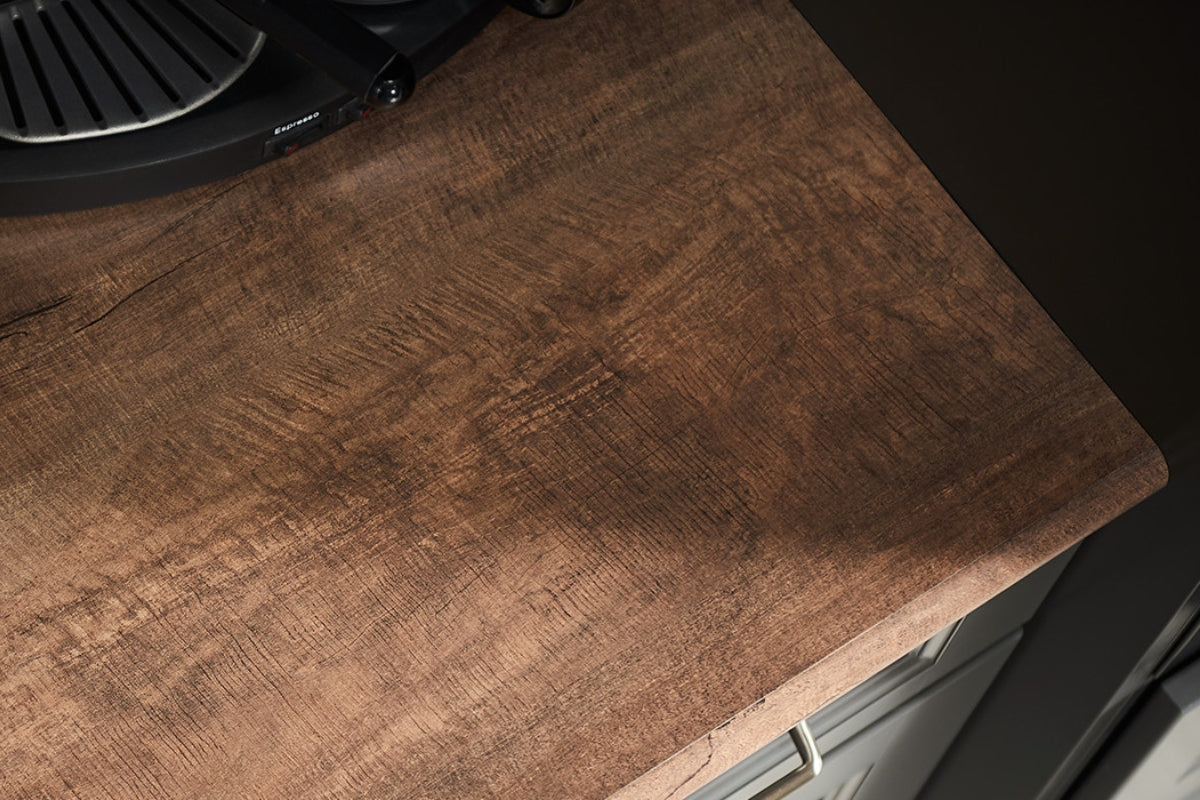 Detail of a surface covered with Formica Laminate Oxidized Beamwood high-pressure laminate (HPL). The texture and aged wood pattern in brown tones are visible.
