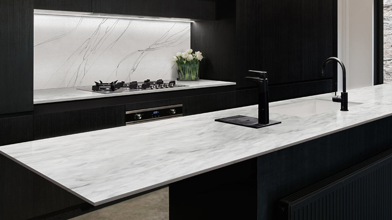 Modern kitchen with a sleek Wilsonart HPL countertop featuring a marble-look surface and black fixtures.