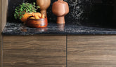 A close-up of a surface featuring Wilsonart® Sabine Walnut HPL, showcasing its sophisticated walnut pattern with a mix of partial cathedrals and straight grain.